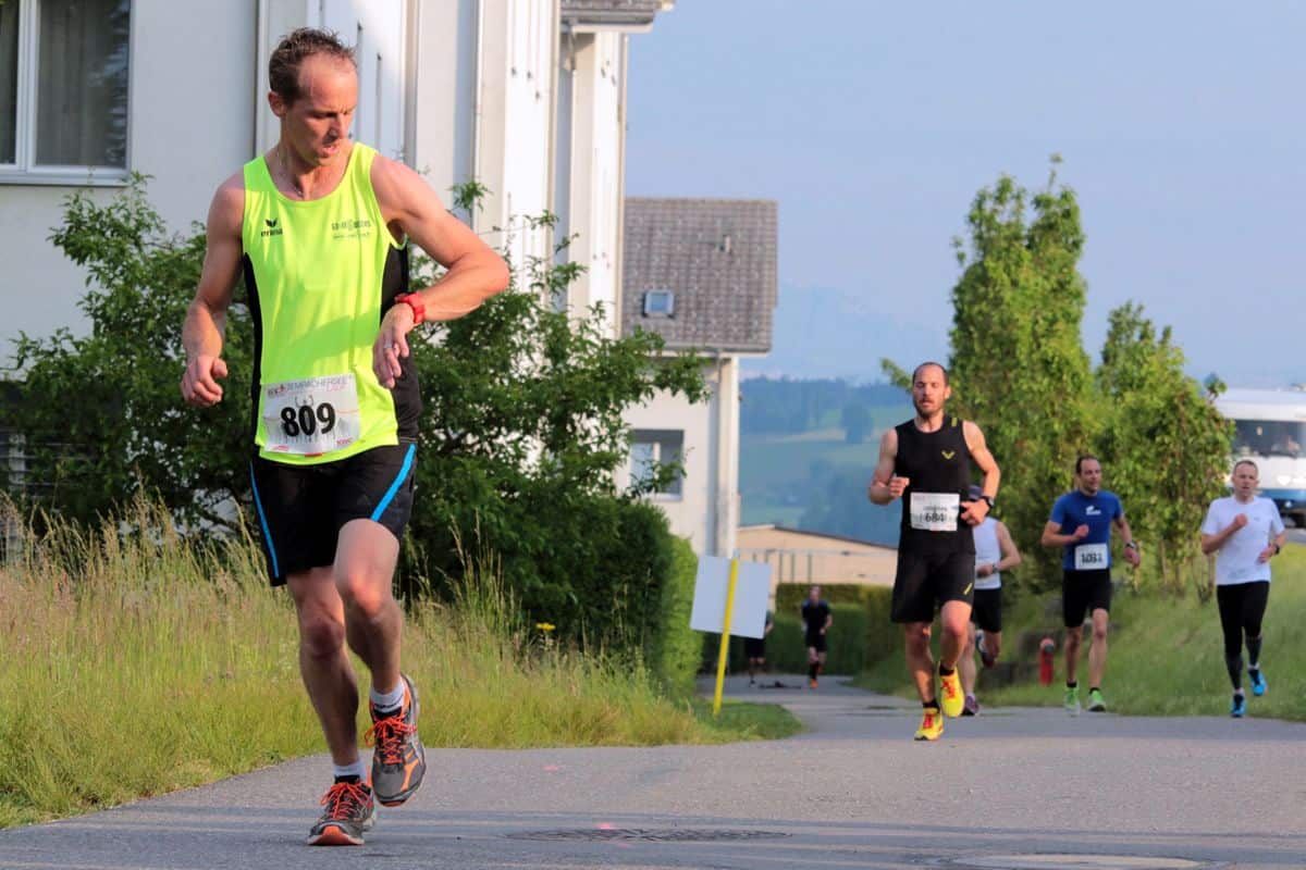 A runner glances at his wearable fitness tracker.