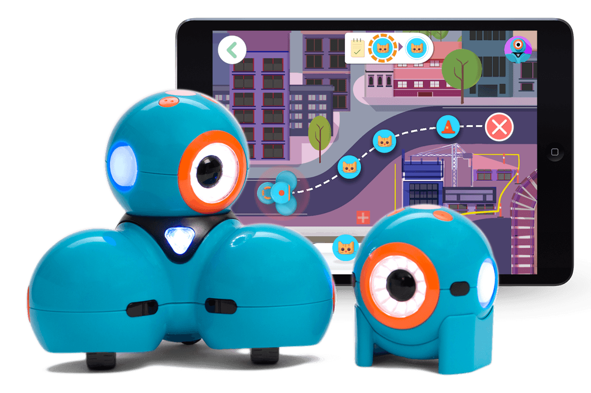 A photo of Dash and Dot, two small, blue, cylindrical robots, each with one big eye, in front of a screenshot of an iPad app showing a cartoon cityscape.