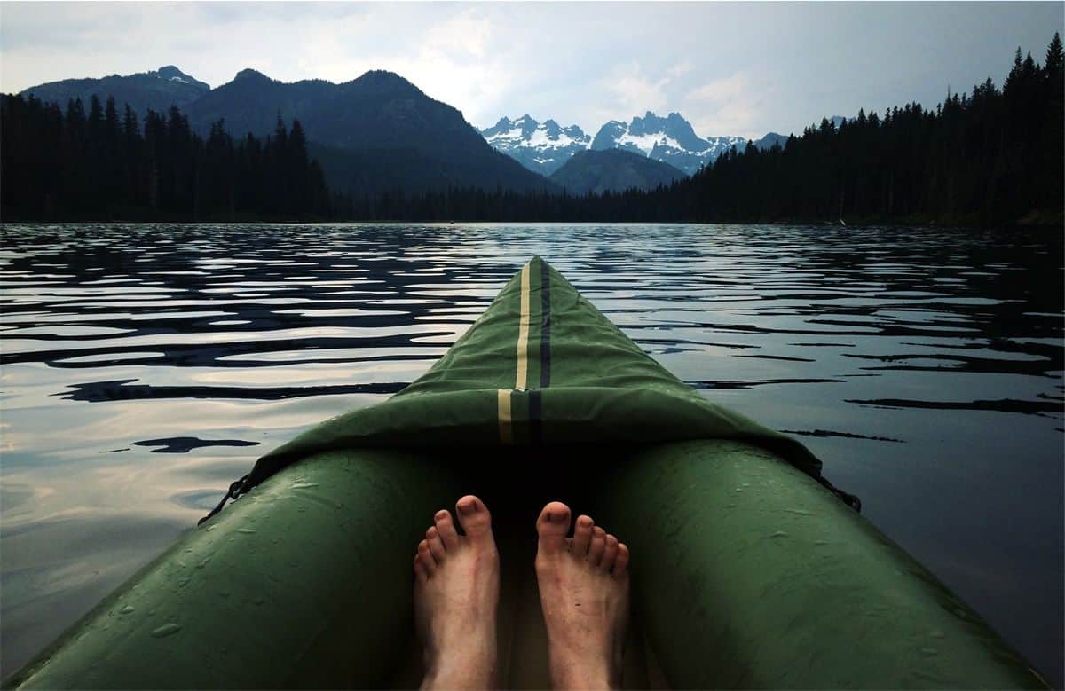 Feet in a floating boat on a lake. Find out what floats your mobile app development team’s boat to better support them.