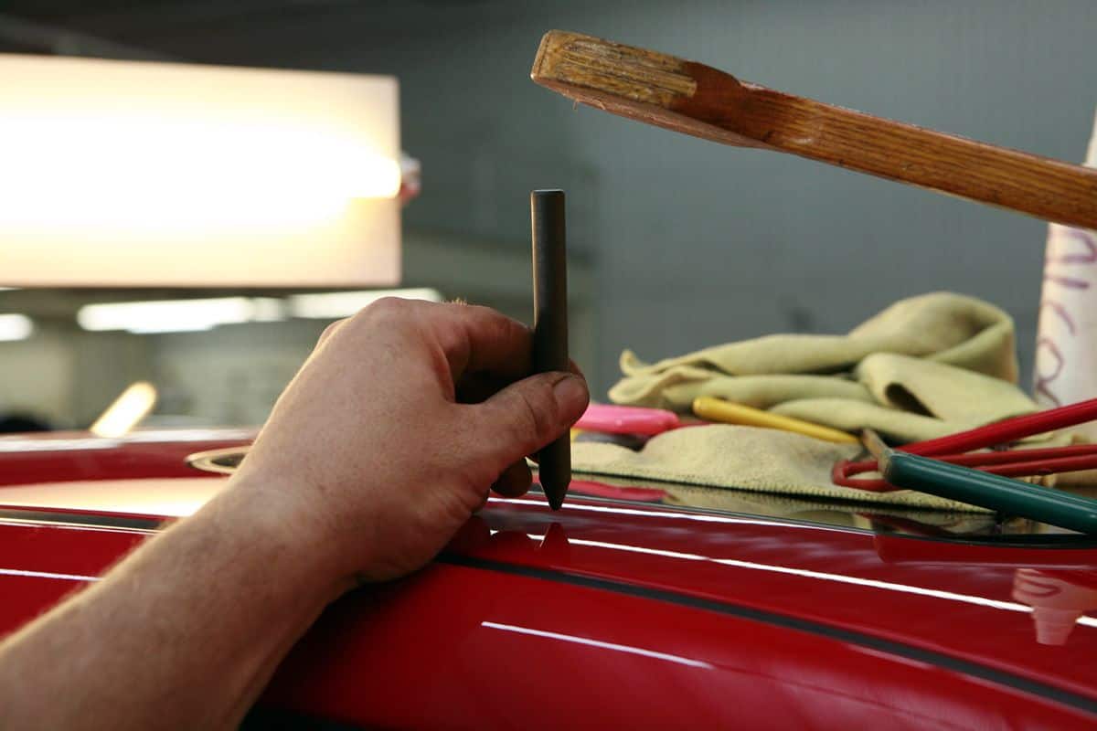 Paint job in car garage using essentials tools. Do not skim on tools for your mobile app development team.