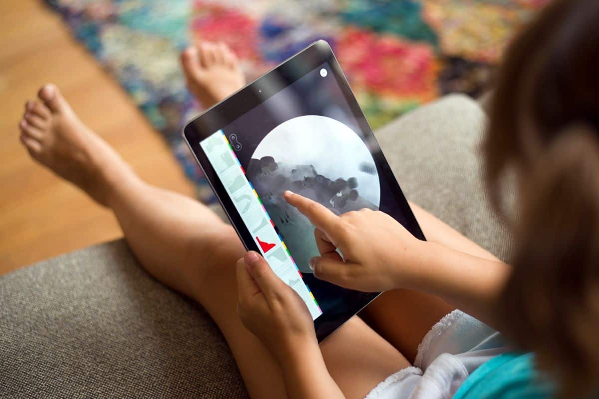 Image of a young child using The Earth mobile app on iPad.