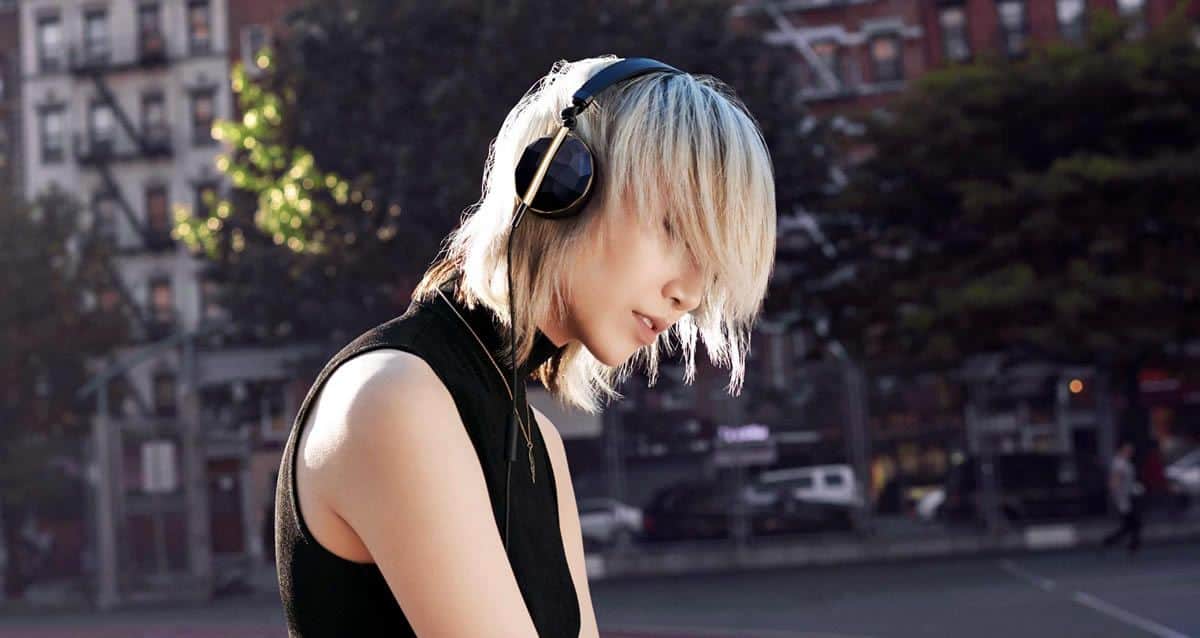 Sideview of a young woman listening to music and enjoying with the black edition of the Linea N1 by Caeden