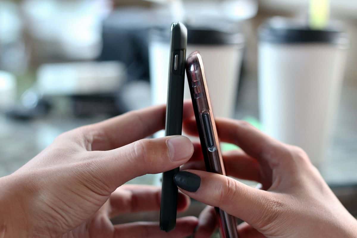 Upclose of two phones slightly touching each other, representing the need to further cross-platform and cross-device compatibility in the future of mobile app development