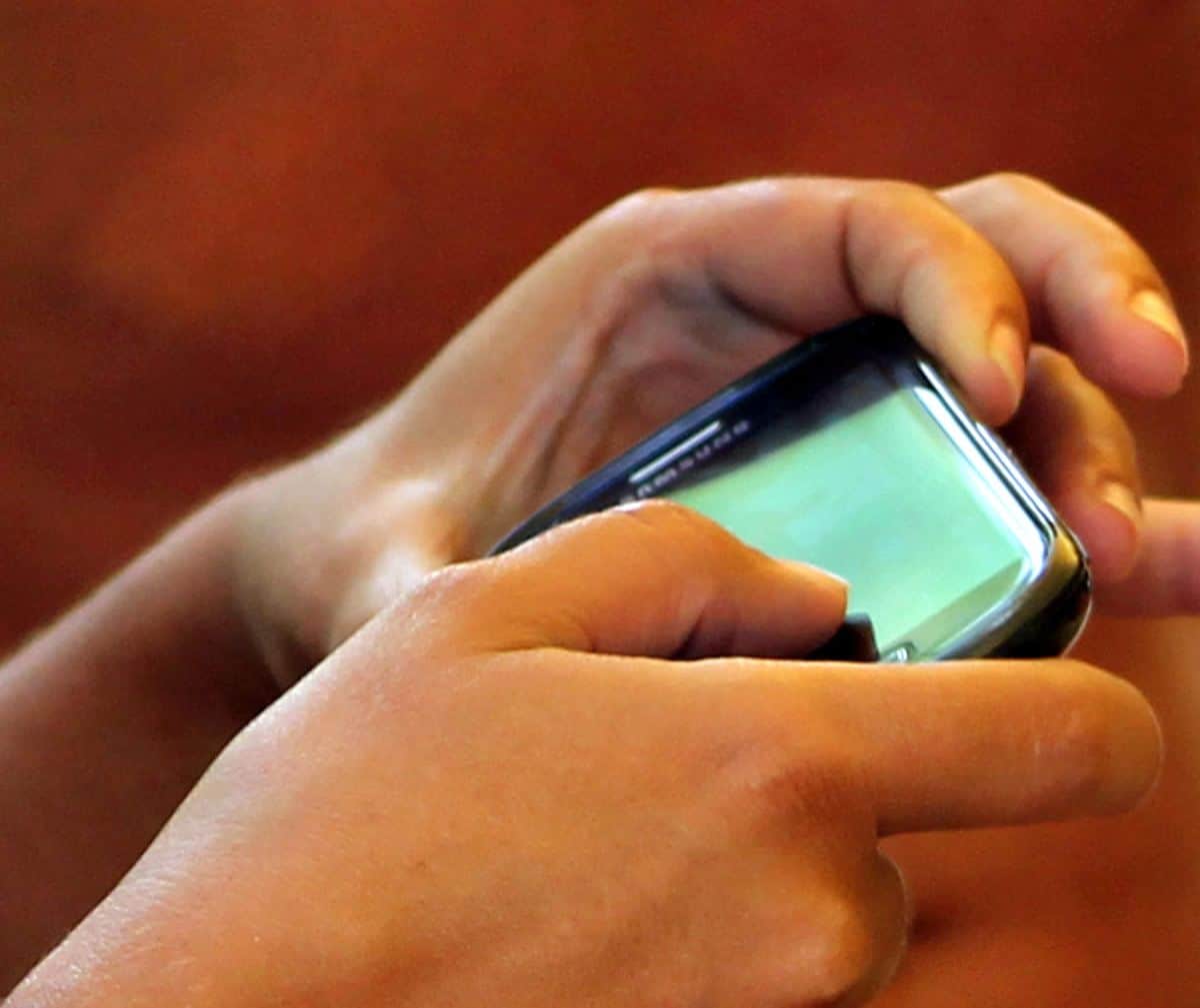 A closeup of two hands using an app on an Android smartphone, illustrating that your own hands can be your most invaluable UX design tools.