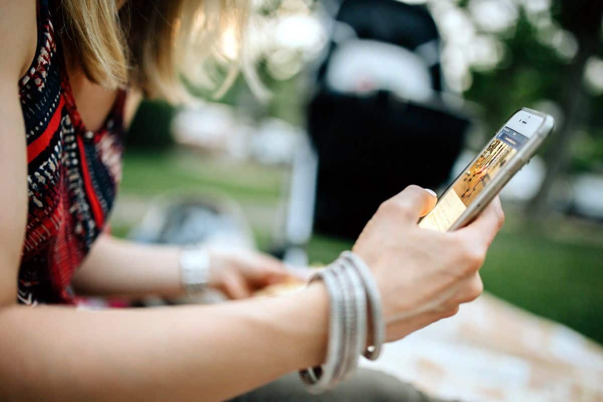 A close-up of a young woman using her mobile phone.