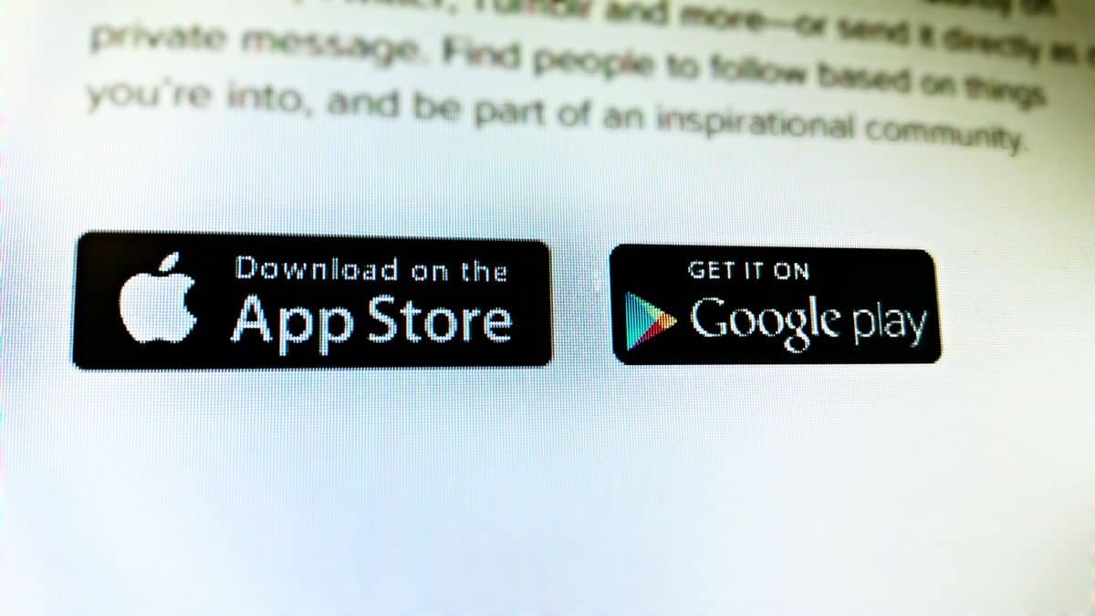 An Apple App Store button next to a Google Play button on a desktop website for a cross-platform app.