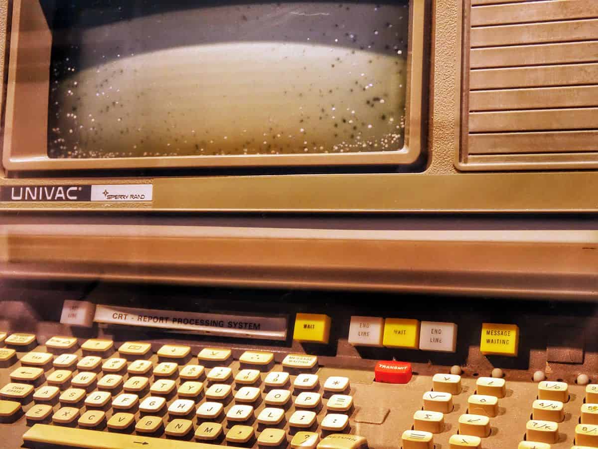 A close-up of an old, yellowed UNIVAC computer terminal.