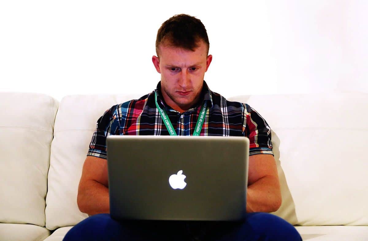 Man on MacBook working hard to learn mobile app development