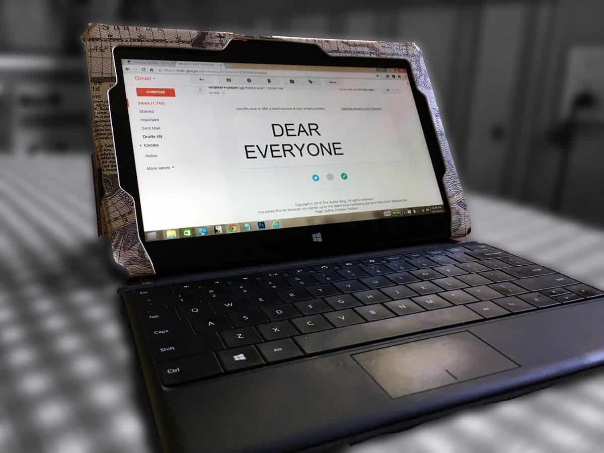 An old laptop displays a Gmail inbox with an email that says “DEAR EVERYONE” in large, all-caps text.