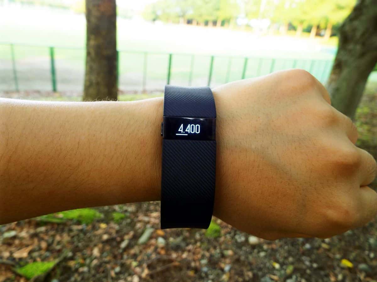 A photo of a person’s arm wearing a Fitbit HR on the wrist, displaying a step count of 4,400.