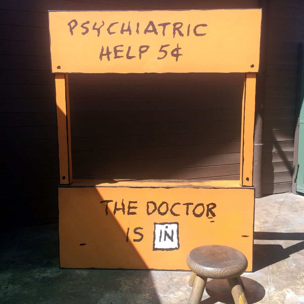 The orange “Psychiatric Help” booth from the comic strip Peanuts.