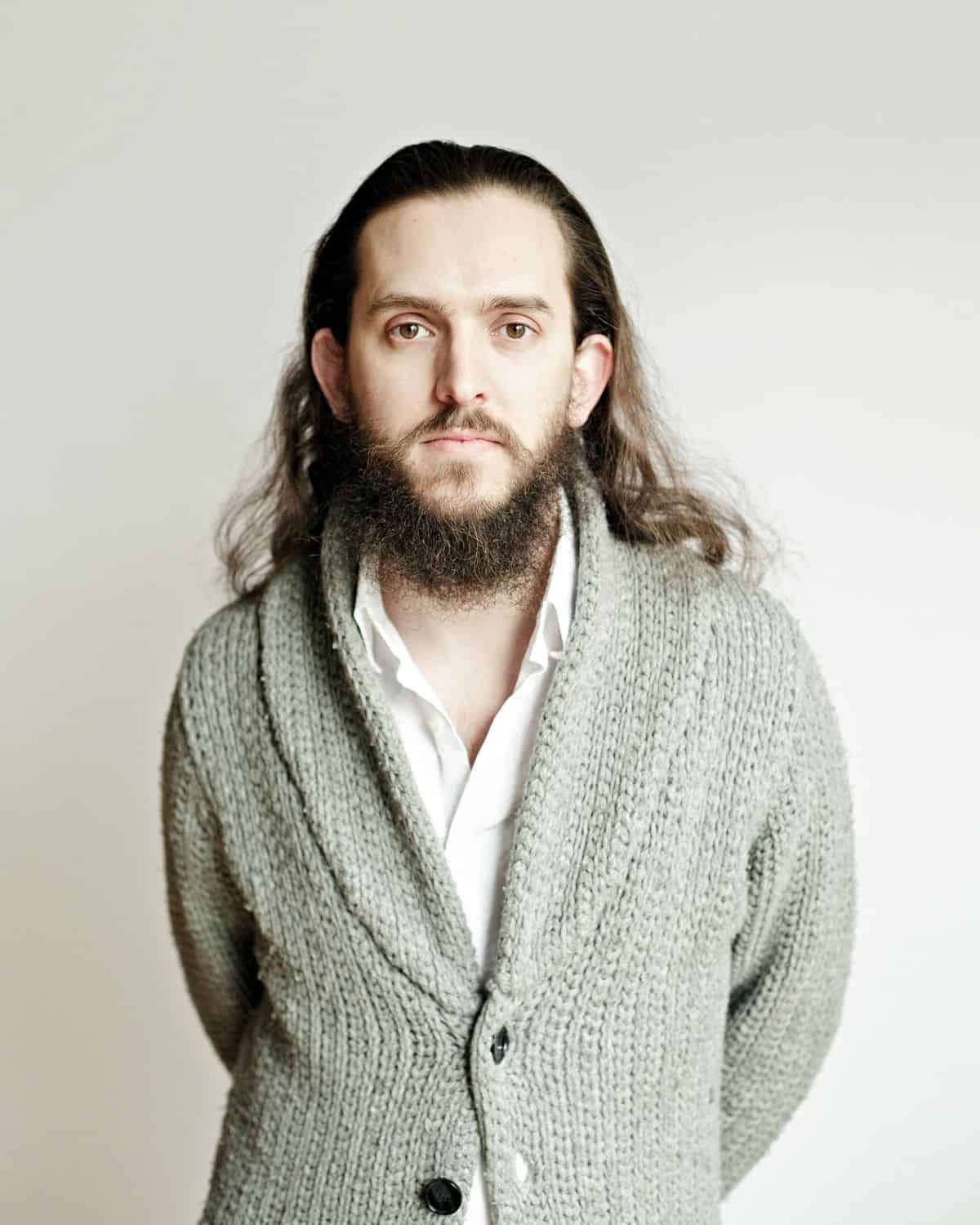 A photo of digital marketing consultant and UX designer Thomas Deneuville wearing a gray sweater, taken by Axel Dupeux.