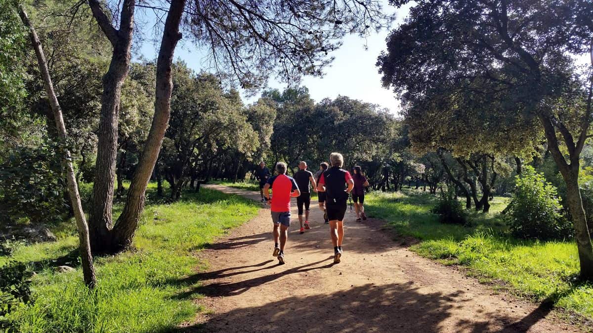 A photo of several trail runners jogging down a dirty path on a beautiful day. Charity Miles is a great example of how to design a mobile app that motivates users to improve themselves and the world around them.