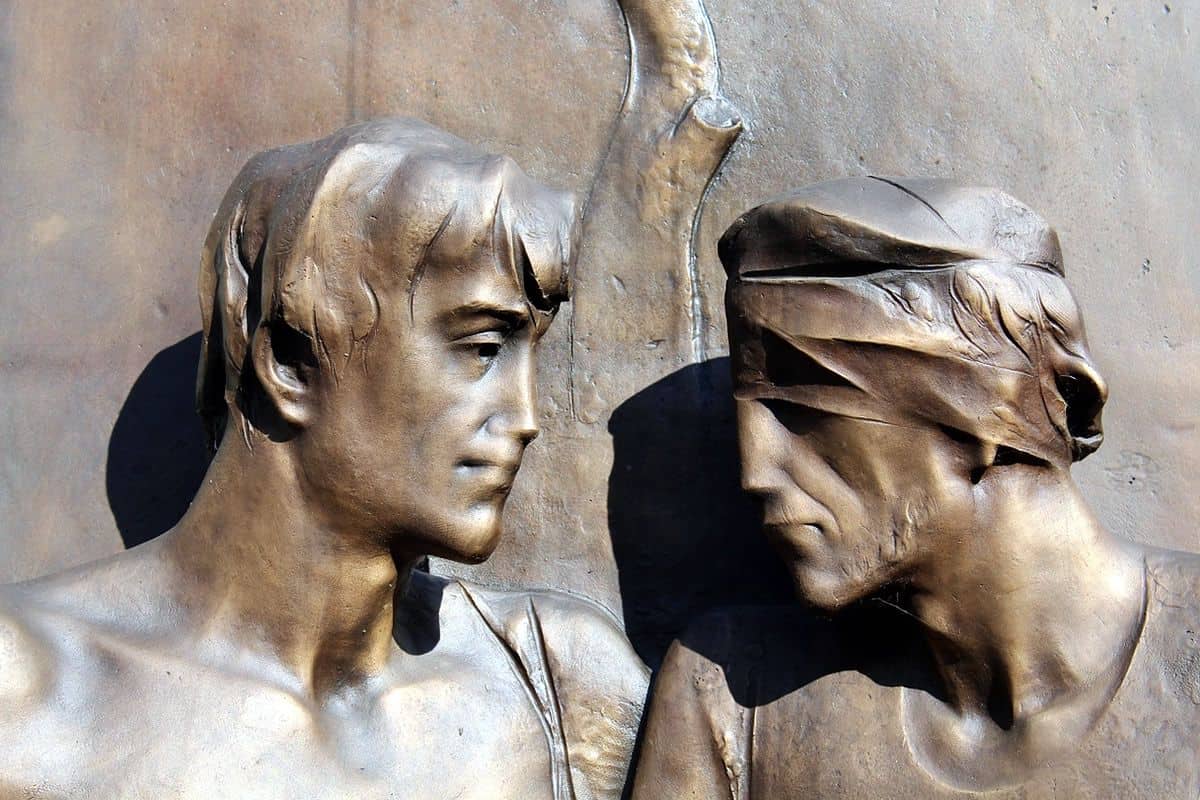 Bronze statue of a man with sight and another blindfolded to signify solidarity with the visually impaired.