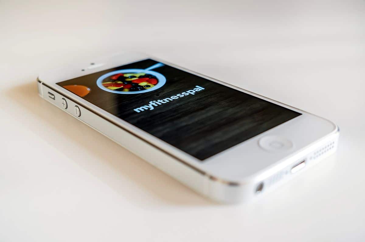 An iPhone displays the splash screen for MyFitnessPal, one of the best examples of how to design a mobile app that takes a complicated goal and makes it attainable for users.