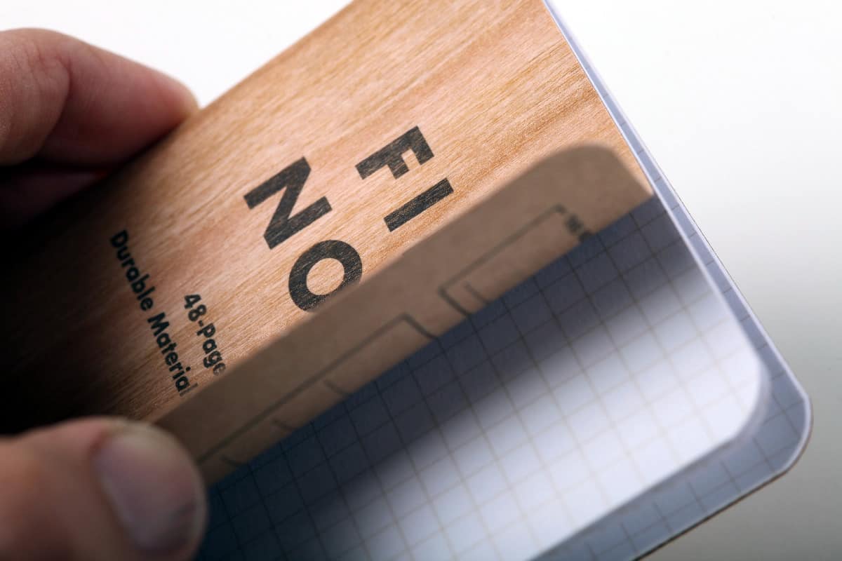 Field Notes with wood design cover slightly opened to reveal graph paper.