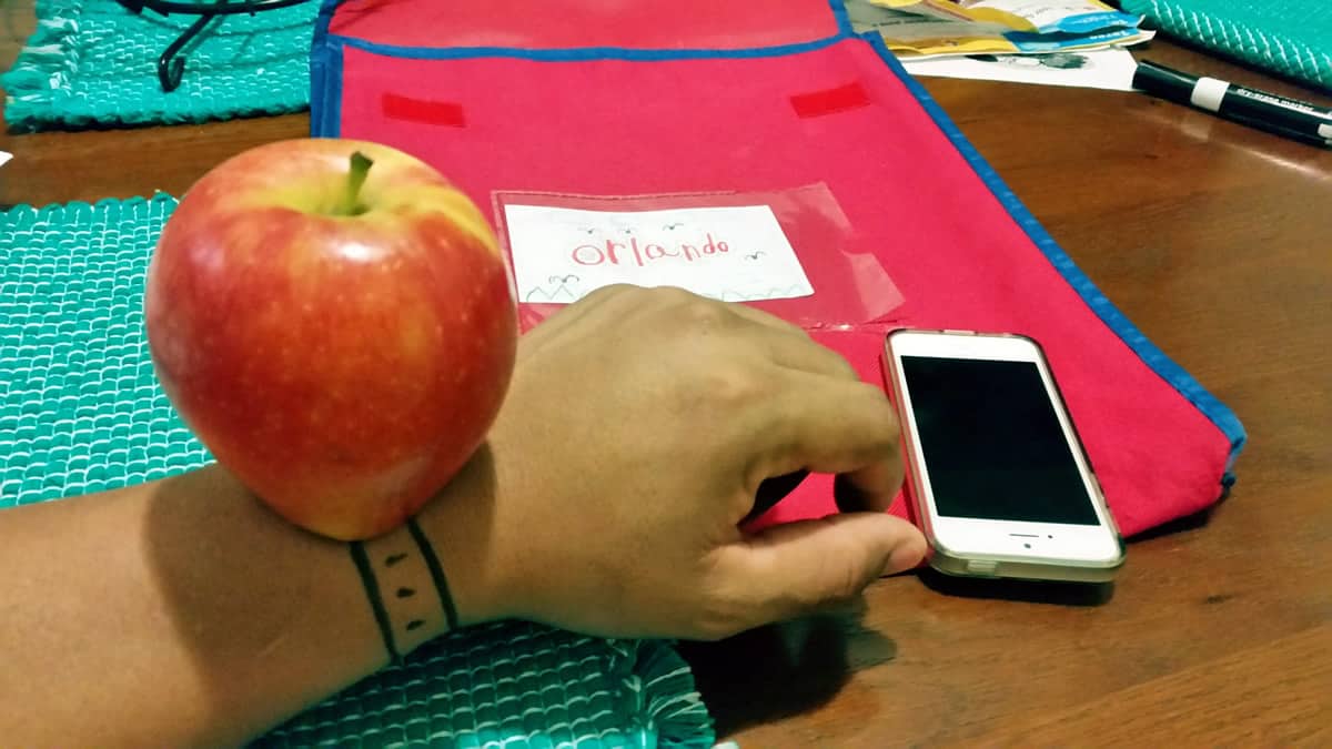 A photo of an apple — that is, the actual fruit — on top of a person’s wrist, upon which a watch strap is drawn in magic marker. There is a smartphone nearby, playing on the name “Apple Watch.” DIY wearable technology at its finest!