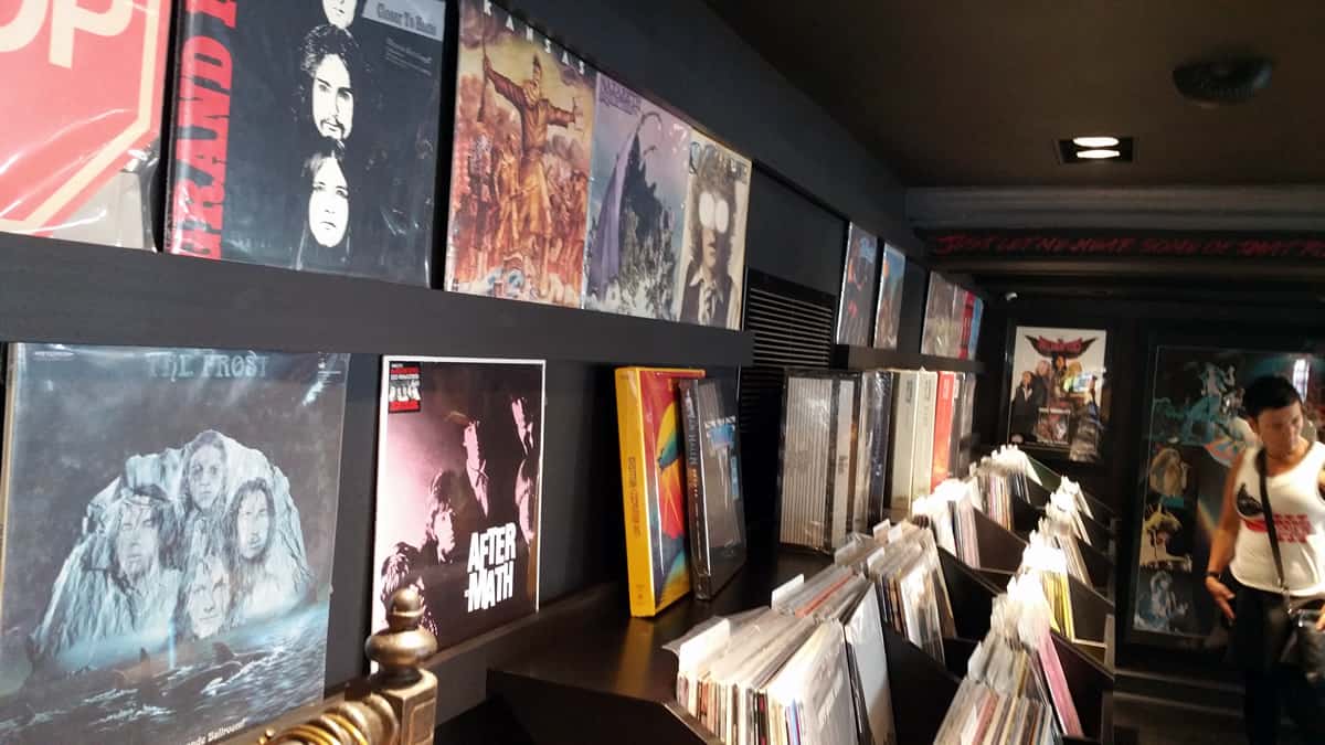 A photo of a record shop with multiple album covers hanging on the wall.