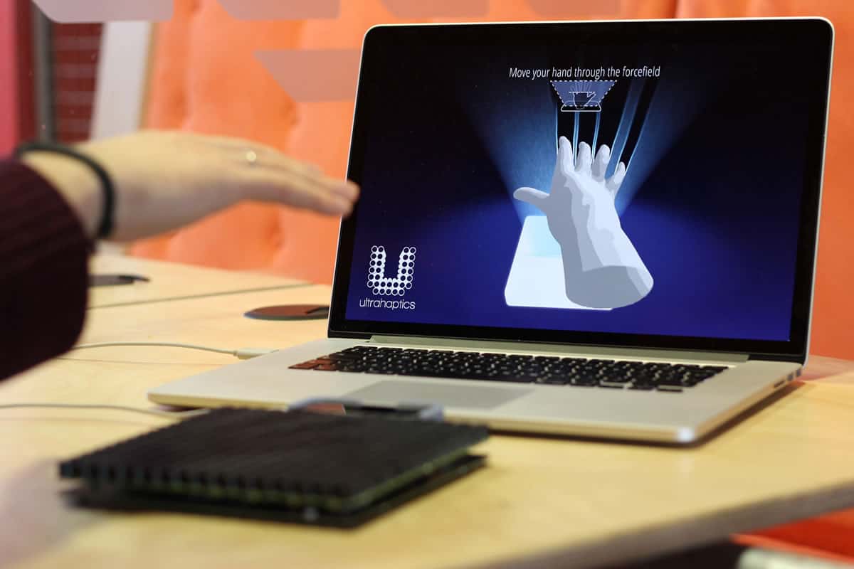 A photo of a person’s hand moving through an invisible forcefield of sound waves during a demonstration of Ultrahaptics’ product.