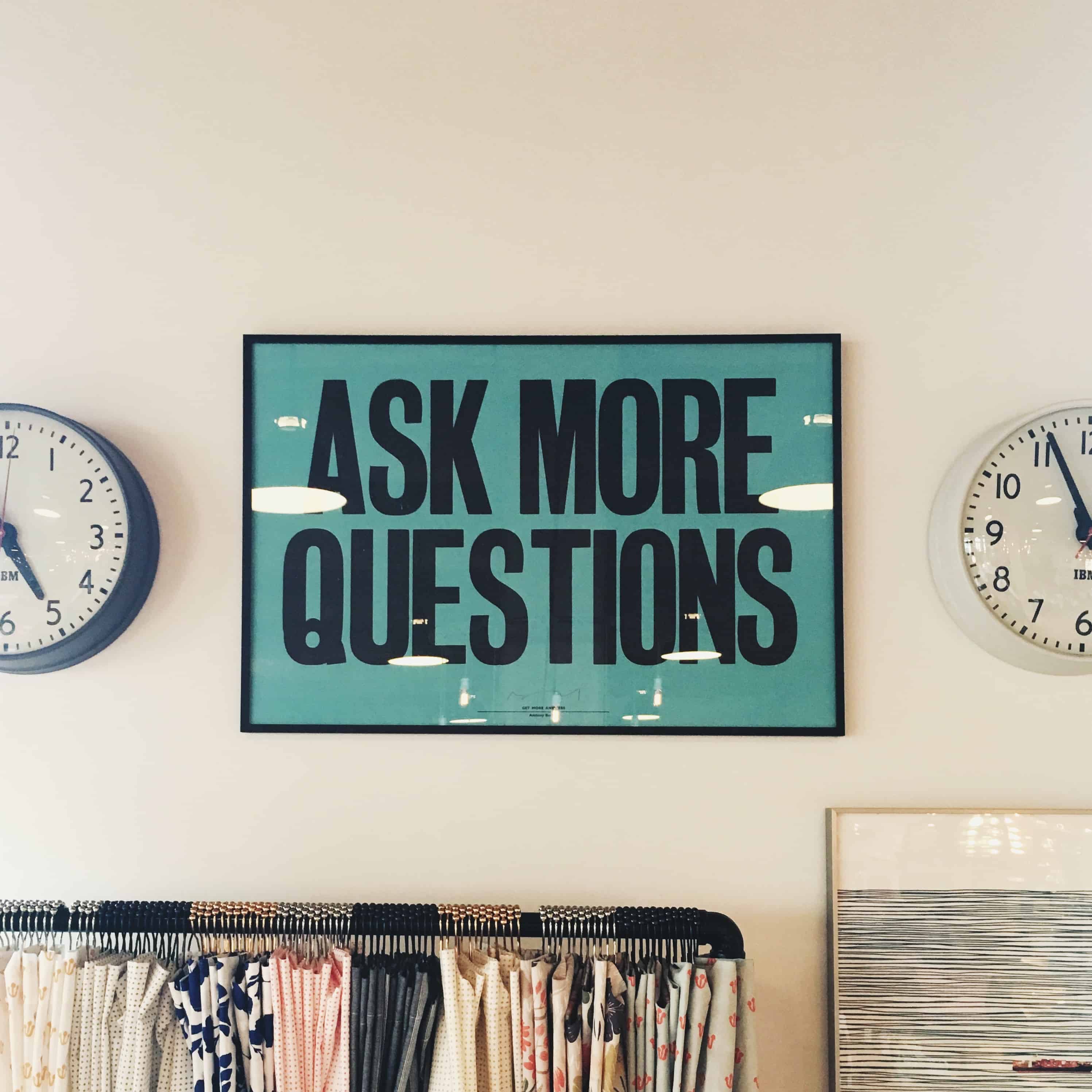 Image of framed poster that says “Ask More Questions.”