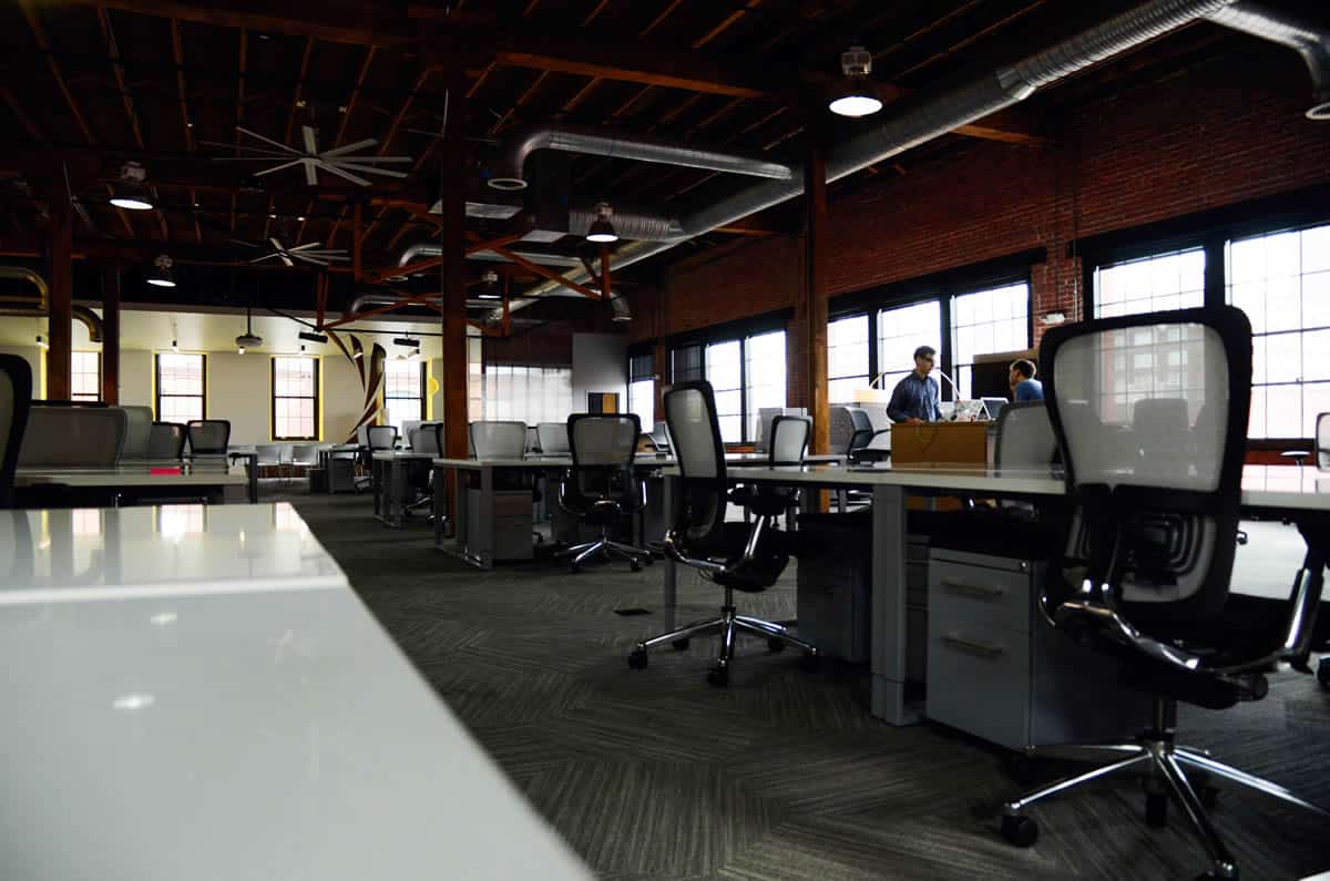 Image of desks and chairs in an office.