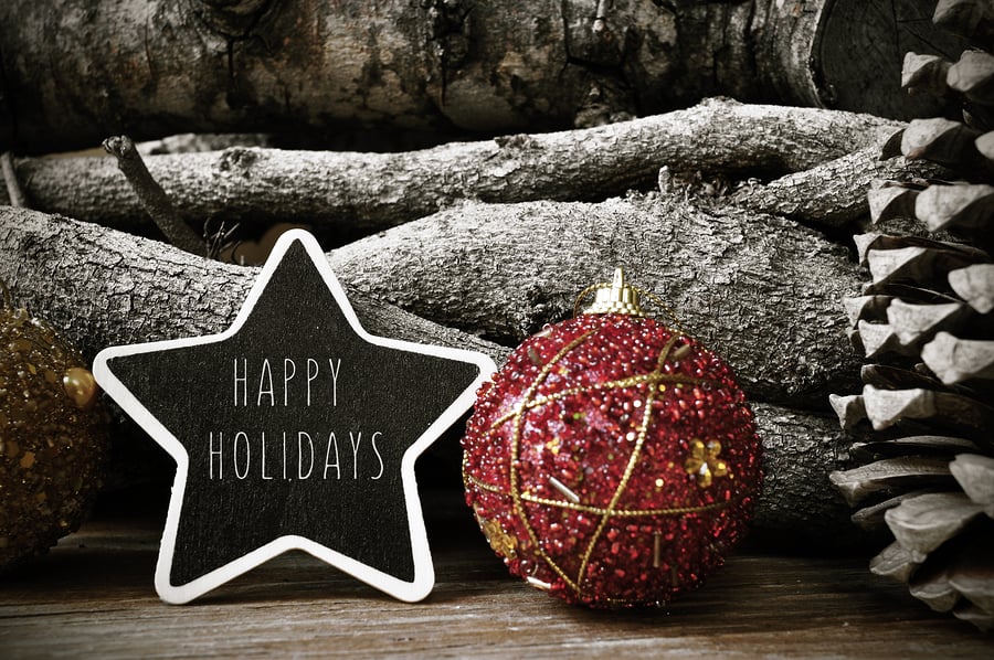 A photo of rustic holiday decorations and a star-shaped sign reading “Happy Holidays.”