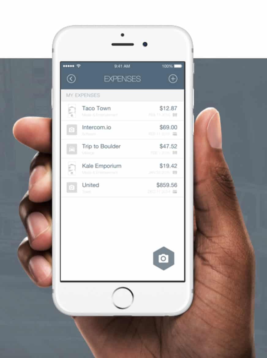 Image of a hand holding a mobile phone with the expense bot expenses page.