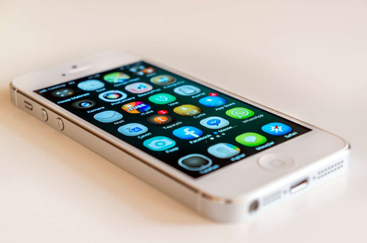 A photo of a white iPhone full of apps.