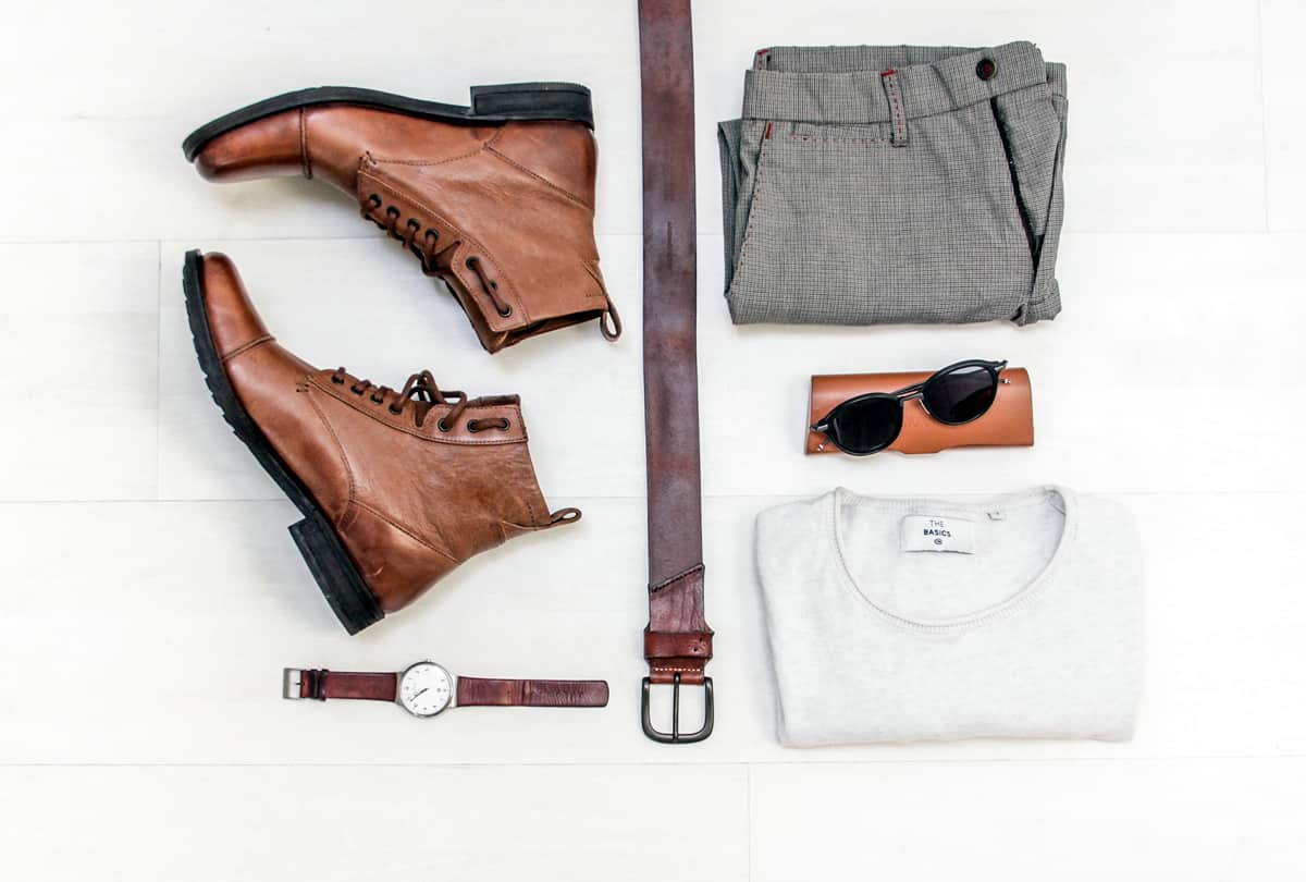 Image of men’s fashion accessories organized on a table.