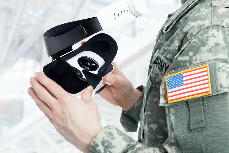 A photo of an American soldier holding a virtual reality headset.