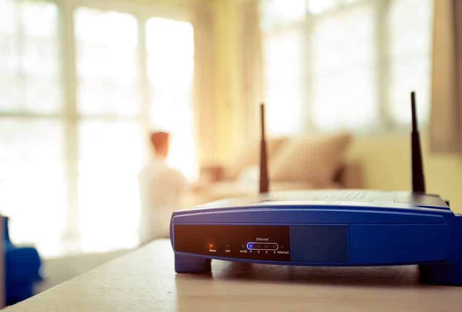 A photo of an ugly wireless router on a table in someone’s home.