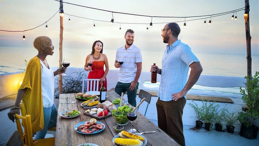 A photo of four people having an outdoor dinner party.