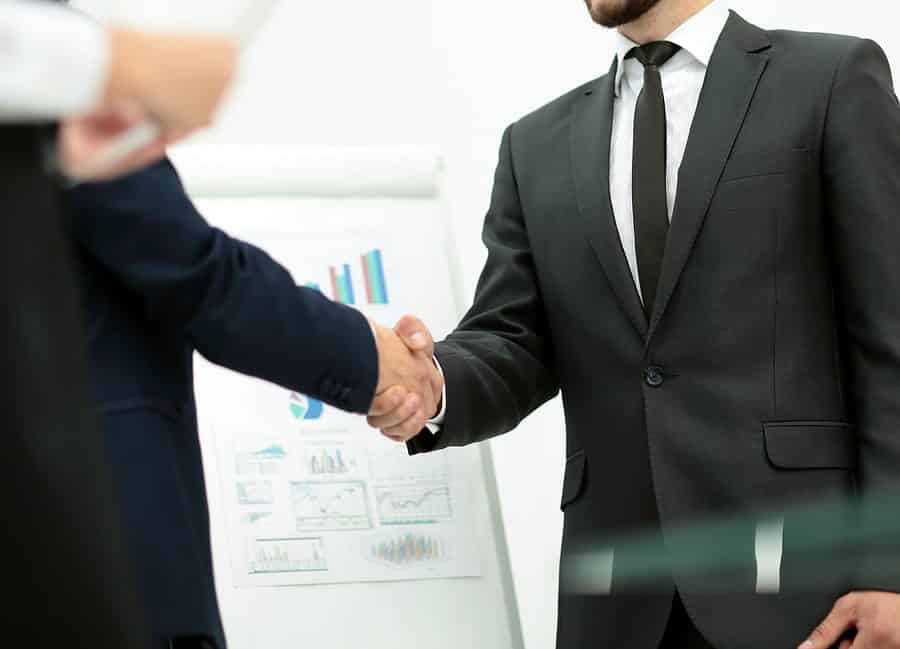 A photo of two gentlemen shaking hands after agreeing upon a business deal.