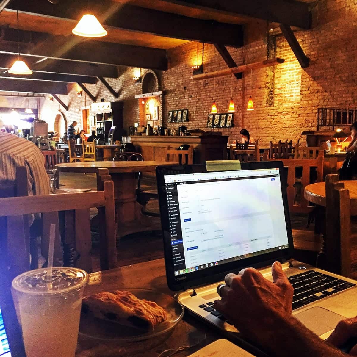 A photo of an entrepreneur working in a coffee house.