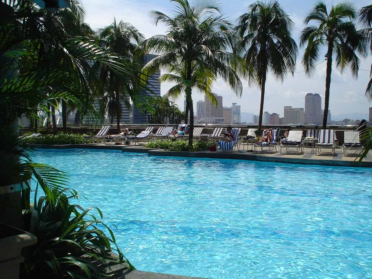 A photo of a gorgeous pool overlooking a city skyline on a warm summer day.