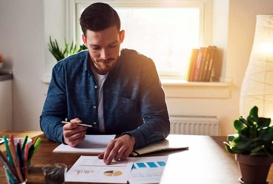 A photo of an entrepreneur working from his home office.