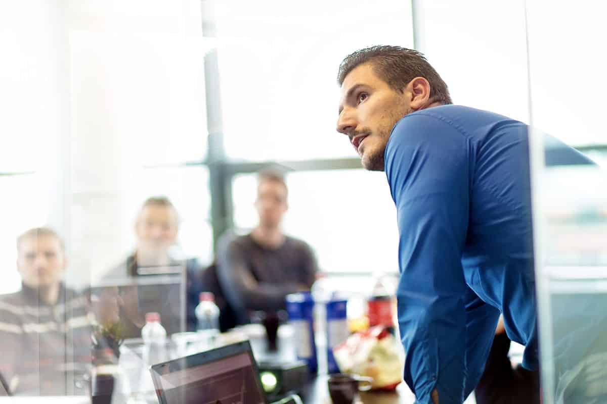 A man delivers a presentation to employees.