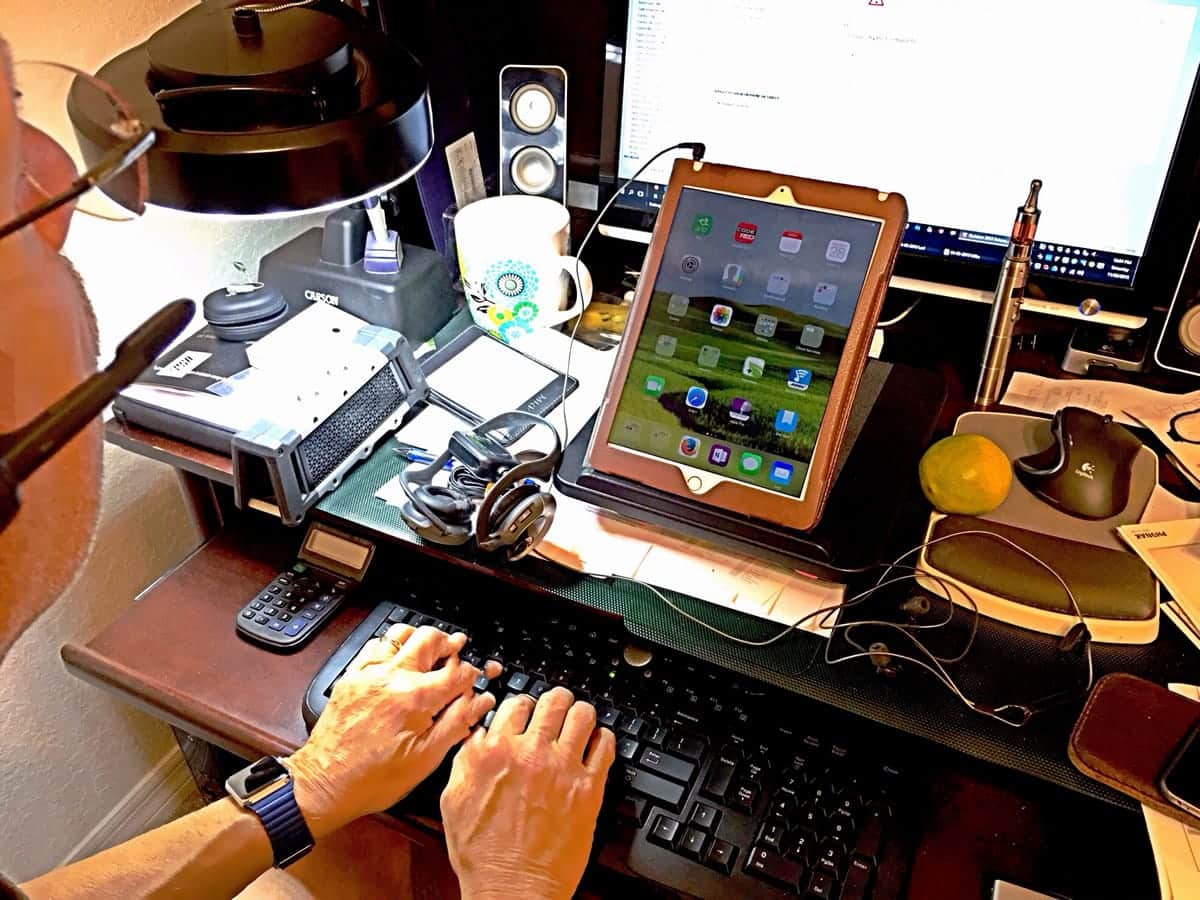 A man does work using a tablet.