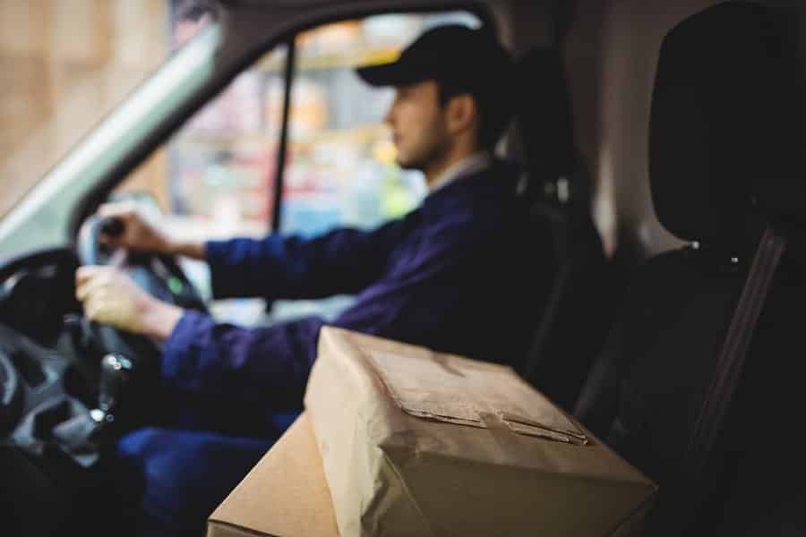 a Delivery man pushing a cart.