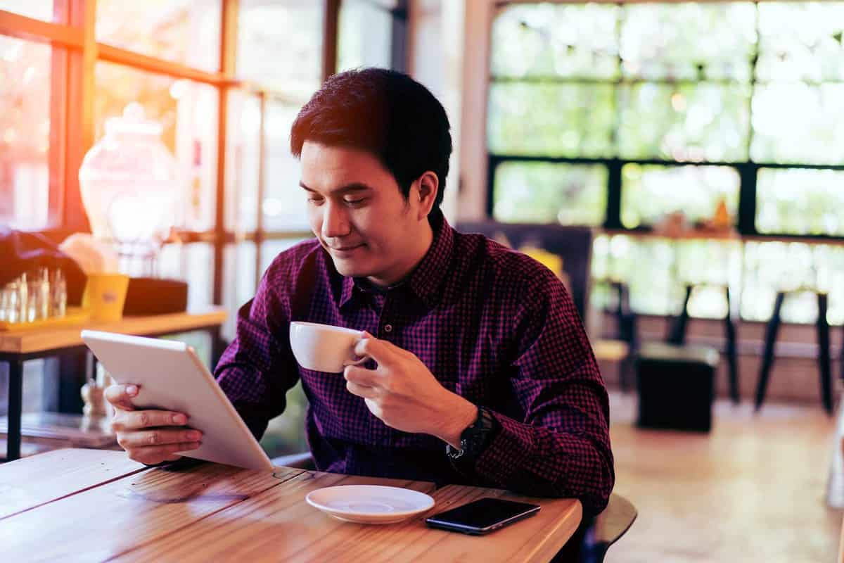 Young businessman on a tablet.