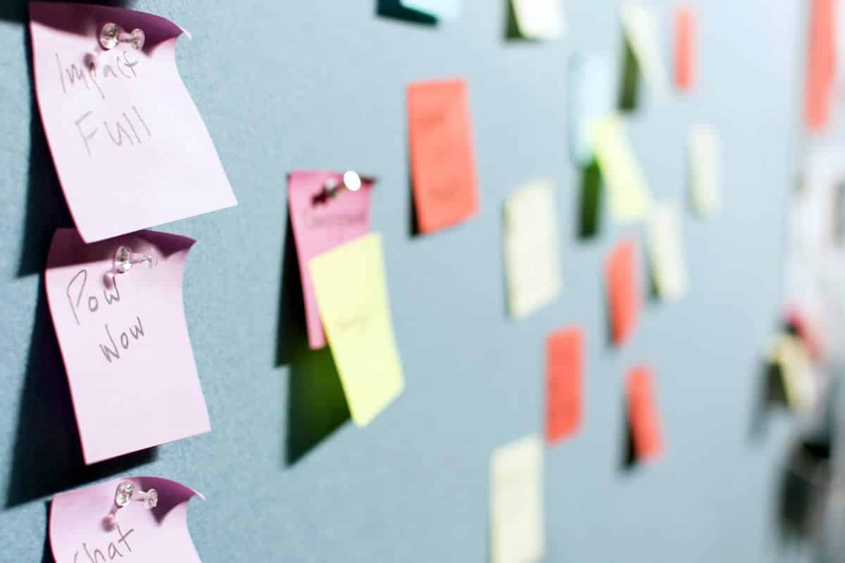 An of multicolored Post-It notes tacked onto a wall.