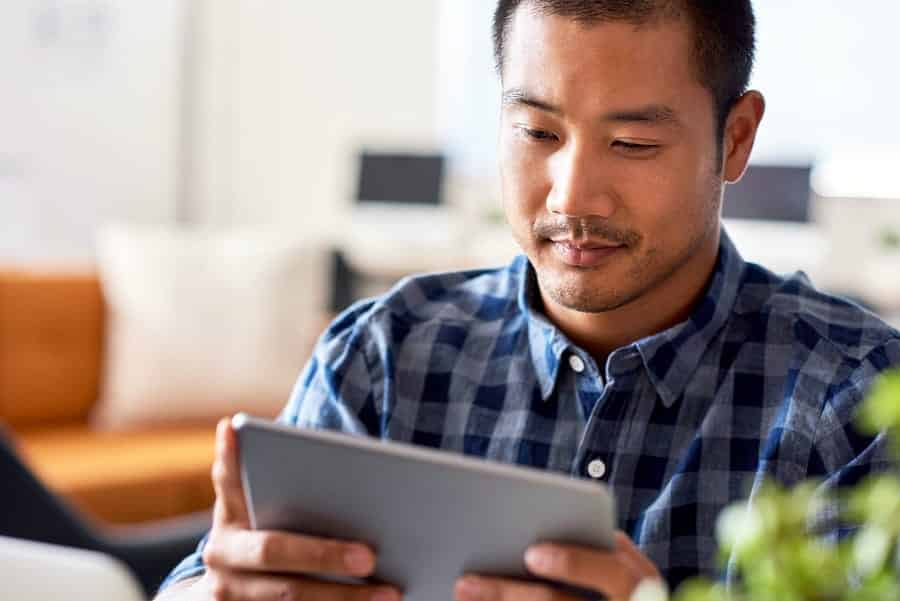 A photo of a man using a tablet.