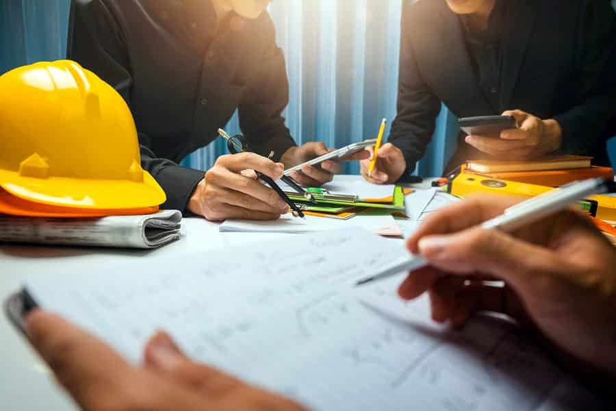 A photo of architects tweaking a design on a construction site.