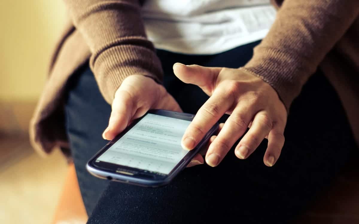 An image of a person trying out an app prototype on a smartphone.