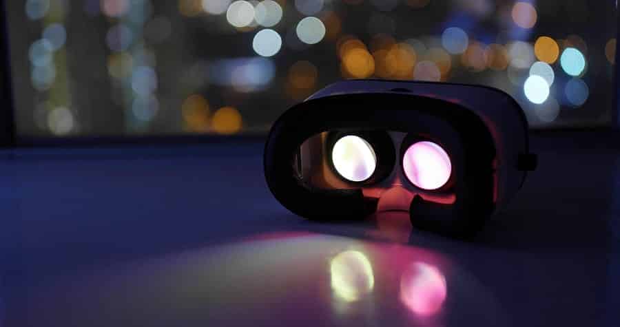 A photo of a virtual reality headset glowing and ready to be strapped on.