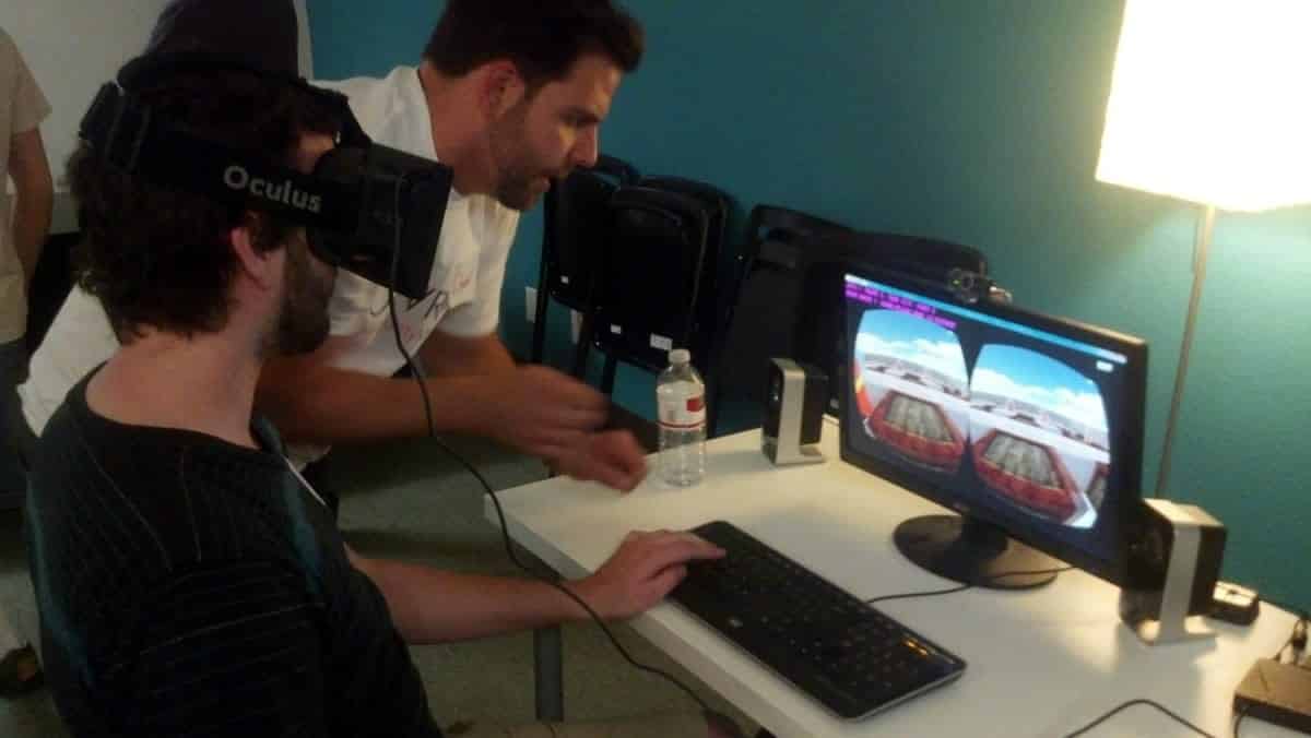 A photo of a person wearing an Oculus Rift while playing a computer game.