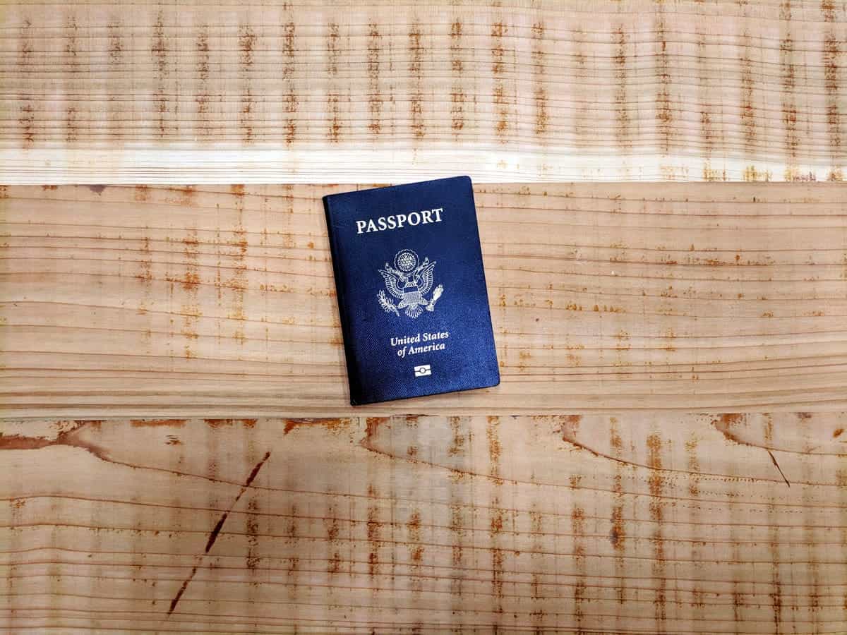 An image of a United States passport on a wooden table.