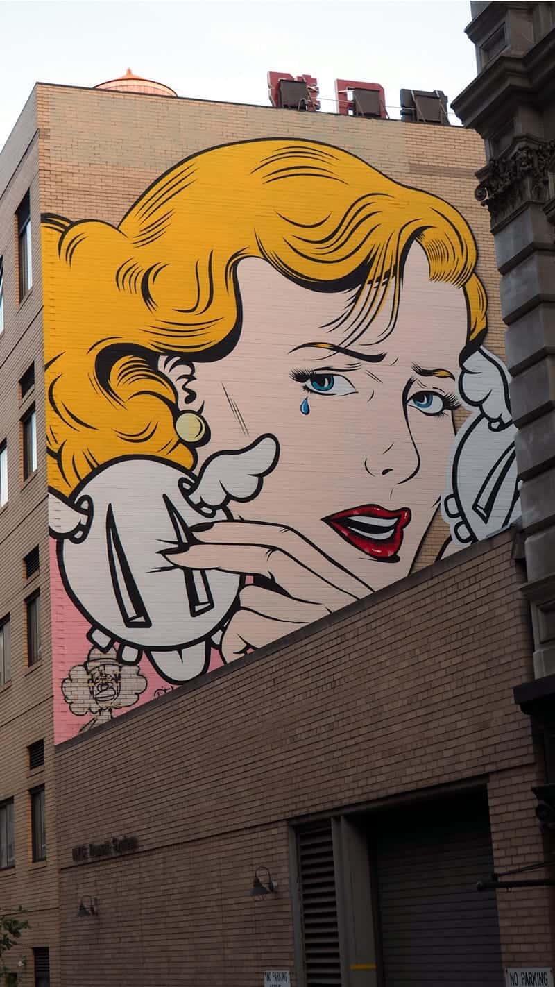 A photo of a Roy Lichtenstein painting on the side of a building.