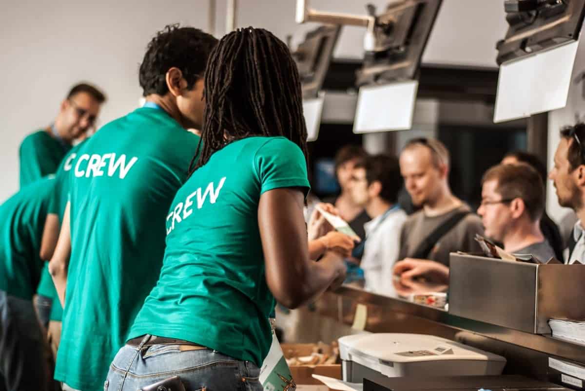 A team working together, wearing green team shirts