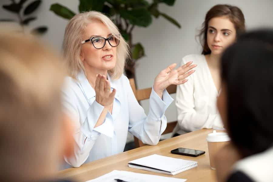 A photo of a woman leading a focus group.